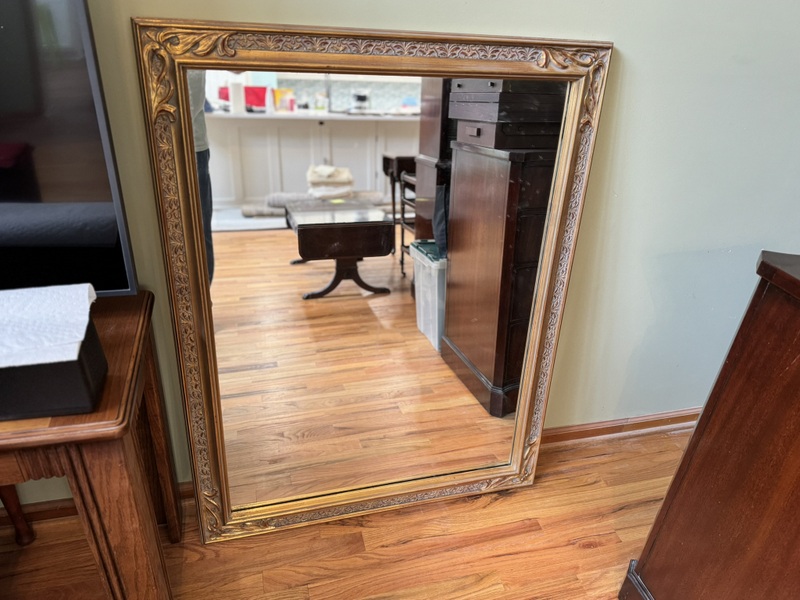 Vintage Beveled Wall Mirror Featuring a Carved Wooden Gold Gilt Frame