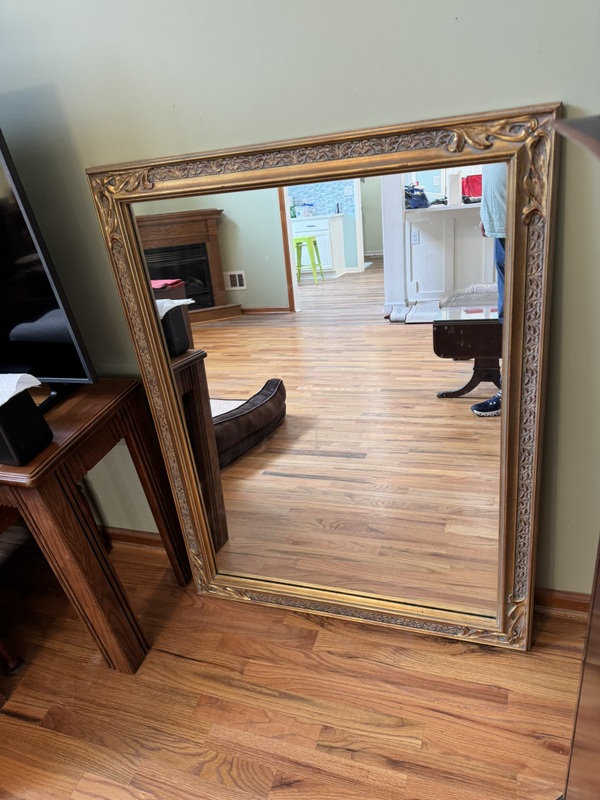 Vintage Beveled Wall Mirror Featuring a Carved Wooden Gold Gilt Frame