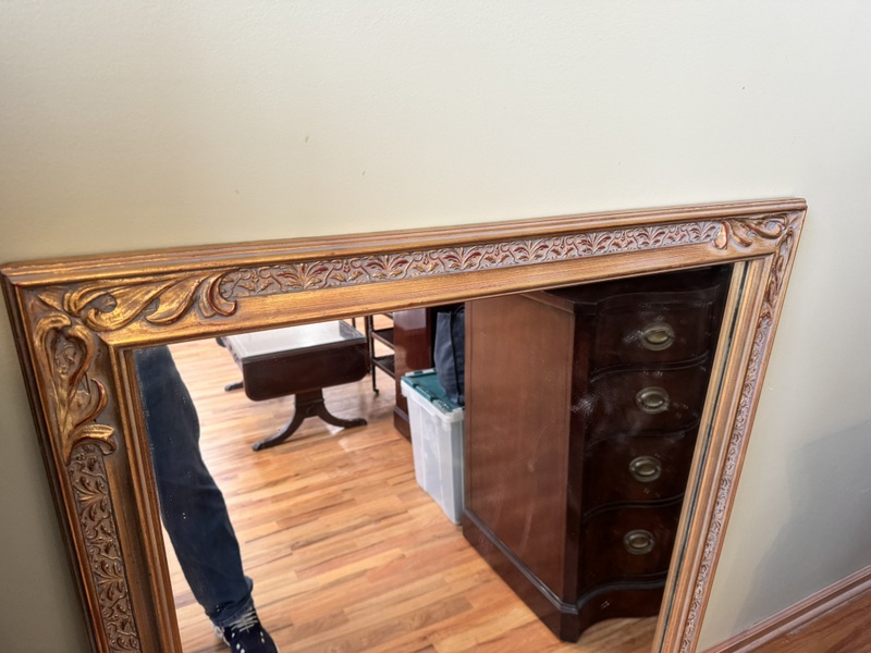 Vintage Beveled Wall Mirror Featuring a Carved Wooden Gold Gilt Frame